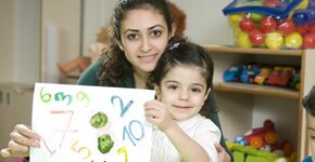Woman and child with a sign.